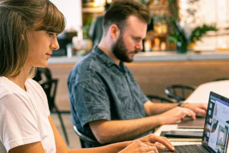Two adults looking at laptop screen