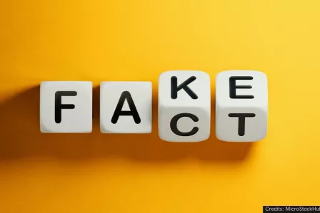 Four dices, each with a letter of the alphabet on it, spelling f-a-k-e and f-a-c-t. The first two dices are the same, the last two are in-between the letters k-c, e-t.