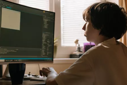 Teenager using a desktop computer
