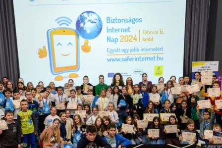 Young people and adults standing for a picture- behind them the SID logo