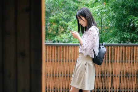 Teenage girl using a mobile device in an outside setting