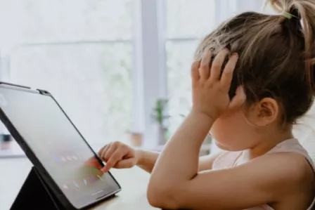 Young girl playing on iPad