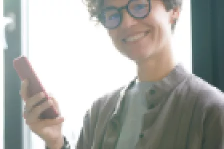 Smiling teenager using a mobile device