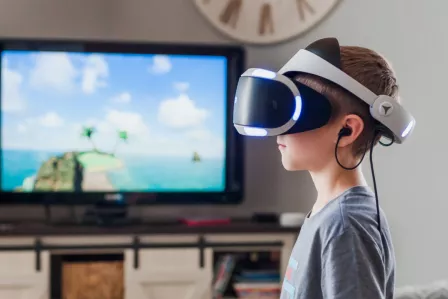 Kid using VR goggles in his living room