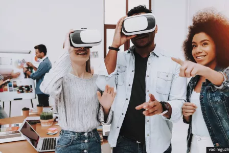 A group of three young people using VR headsets