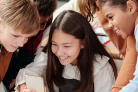 Young people looking at a mobile phone screen