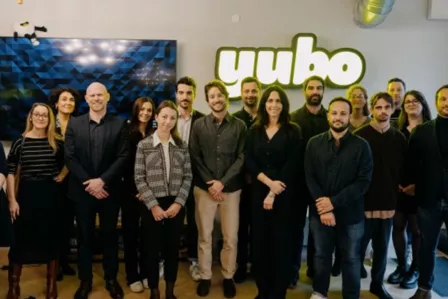 Crowd of people standing with 'Yubo' in the background