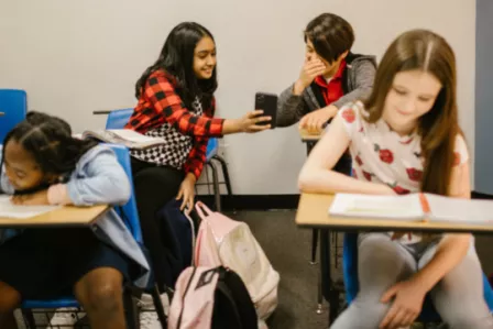 Children sat at desks in a classroom setting