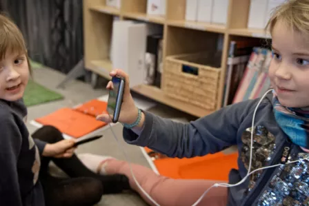 Child showing peers content from a device