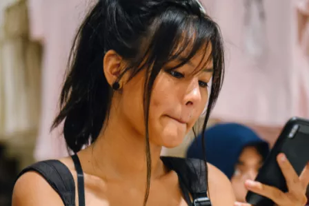 Young girl looking at mobile phone