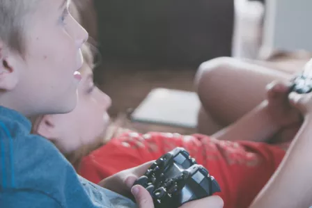 Children holding game controllers
