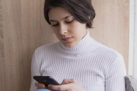 Young woman looking at smartphone