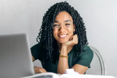 Smiling woman working on a laptop