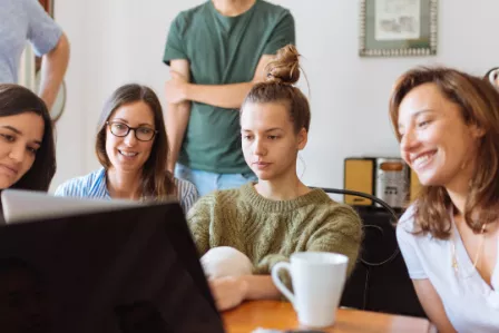 Group of young people looking at laptop