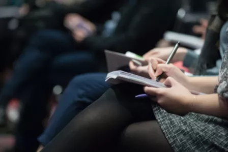 Woman writing on notepad