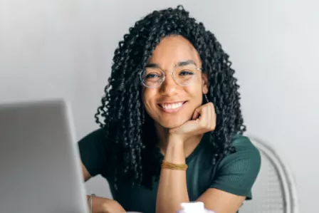 Smiling woman using a laptop