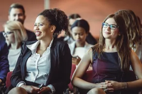 Two young women sitting during a conference