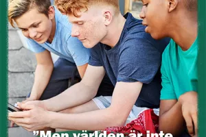 Three young boys looking at a mobile phone screen.