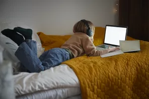 Child looking at the laptop. 