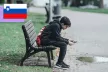 Boy sitting on a bench using his phone