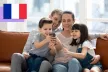 A happy family using smartphones.