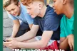 Three young boys looking at a mobile phone screen.