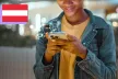 A young person of colour using an AI app on their smartphone