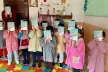 Group picture of young children participating in the activities, holding a book to cover their faces given the young age