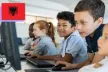 A group of five school mates looking at computer screens and using a mouse