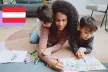 Mom playing coloring a book with her two sons