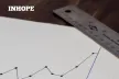 A graph on a piece of paper and two pens