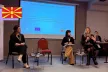 Three young people on stage during a session at the youth panel event in Skopje, North Macedonia