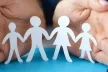 Women hands protecting a family with children from paper
