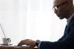 Man using a laptop in an office environment