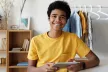 Smiling teenager using a tablet device