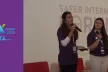 Two young girls speaking at a conference