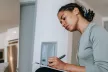 Woman writing on a notebook