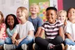 Group of young children sitting cross legged on the floor