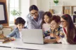 young people and woman in front of a laptop