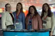 Croatian SIC team in front of a booth in a convention.