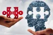 Two hands holding a piece of a puzzle and the figure of a head missing a space the size of the puzzle piece