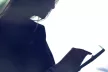 Shadow of a girl looking at an electronic device