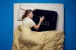 Woman sleeping with an over-sized smartphone