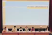 Picture of conference panel sitting at a table