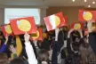 Young people raising hands with emojis