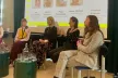4 women discussing on stage