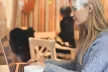 Woman using a laptop in a café setting