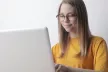 Teenage girl staring at a laptop screen