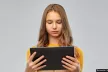 Girl on tablet with grey background