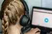 Girl with headphones watching a screen